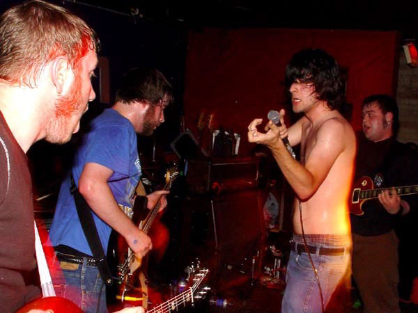 George Pettit aiming his "shotgun" at Dallas Green as the band begins a song at Babylon Nightclub in Ottawa in 2003. Photo: Junked Camera