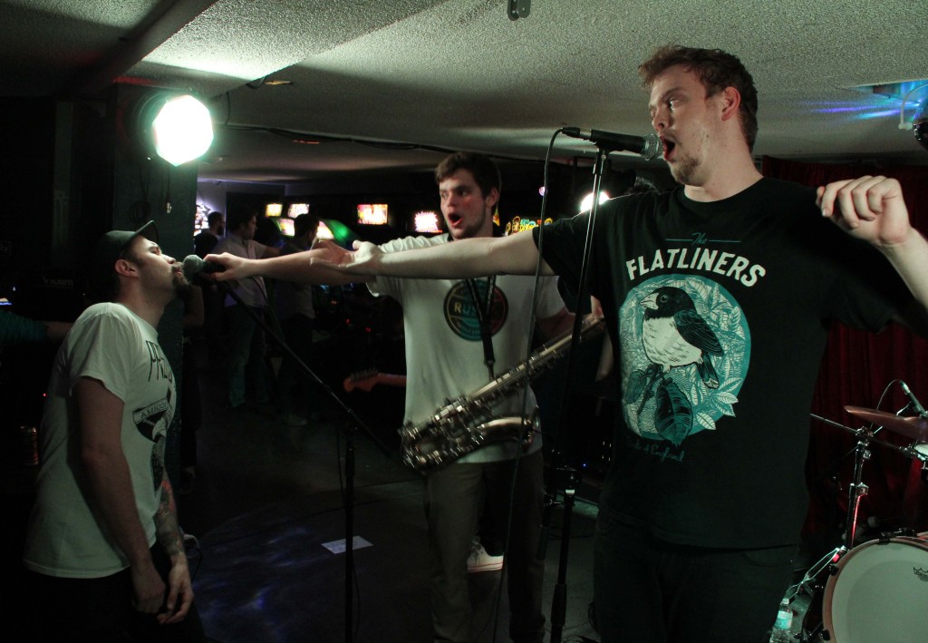 Suits 'n Toques passing the mic to JS to sing along at House of Targ's one year anniversary. Photo: Eric Scharf